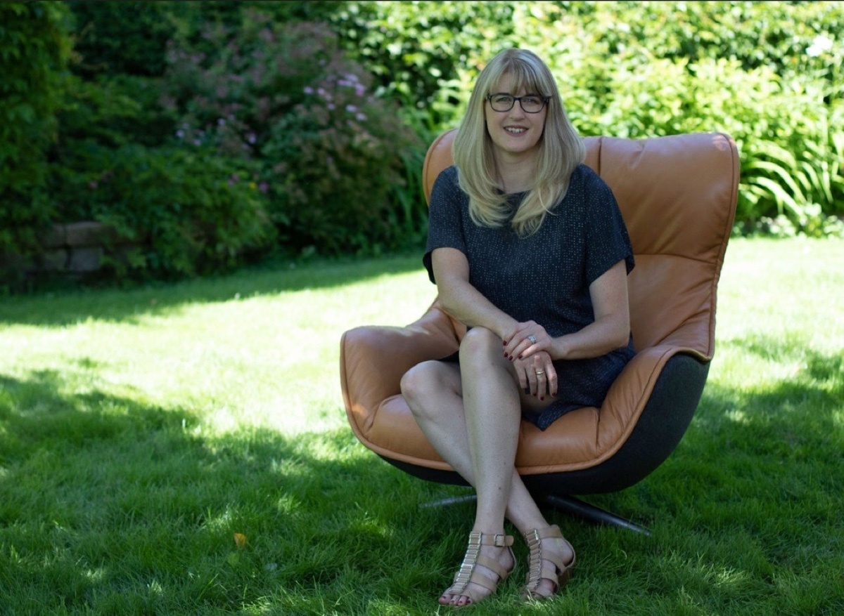Diane Snelgrove sitting in a chair in the grass