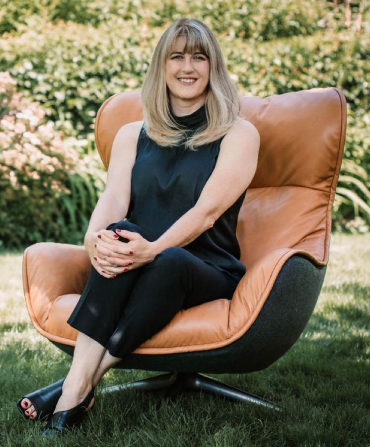 Diane Snelgrove sitting in a chair in the grass